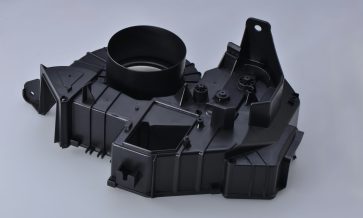 Injection-molded plastic housing with ribs, bosses, mounting points, and assembly features